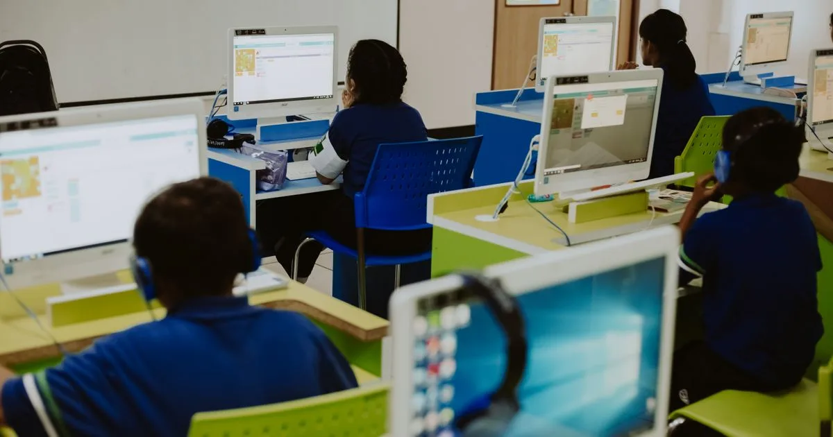 Students using desktop computers in a classroom computer lab